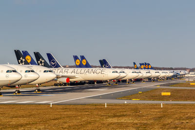 Airplane on airport runway against clear sky