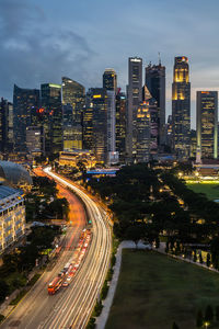 High angle view of illuminated street amidst buildings in city