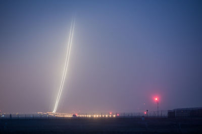 Illuminated building against sky at night