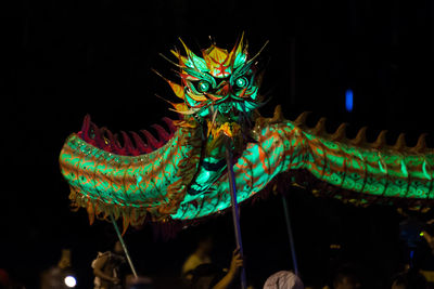 People carrying chinese dragon at night