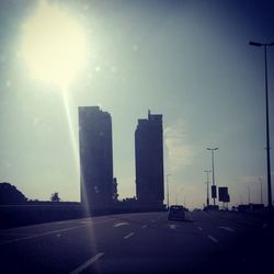 Cars moving on road at sunset