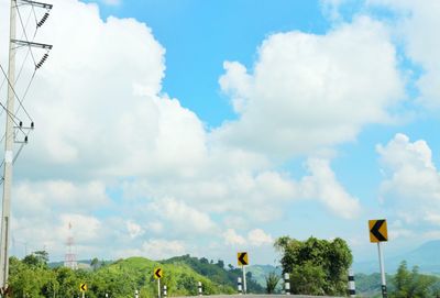 Road sign against sky