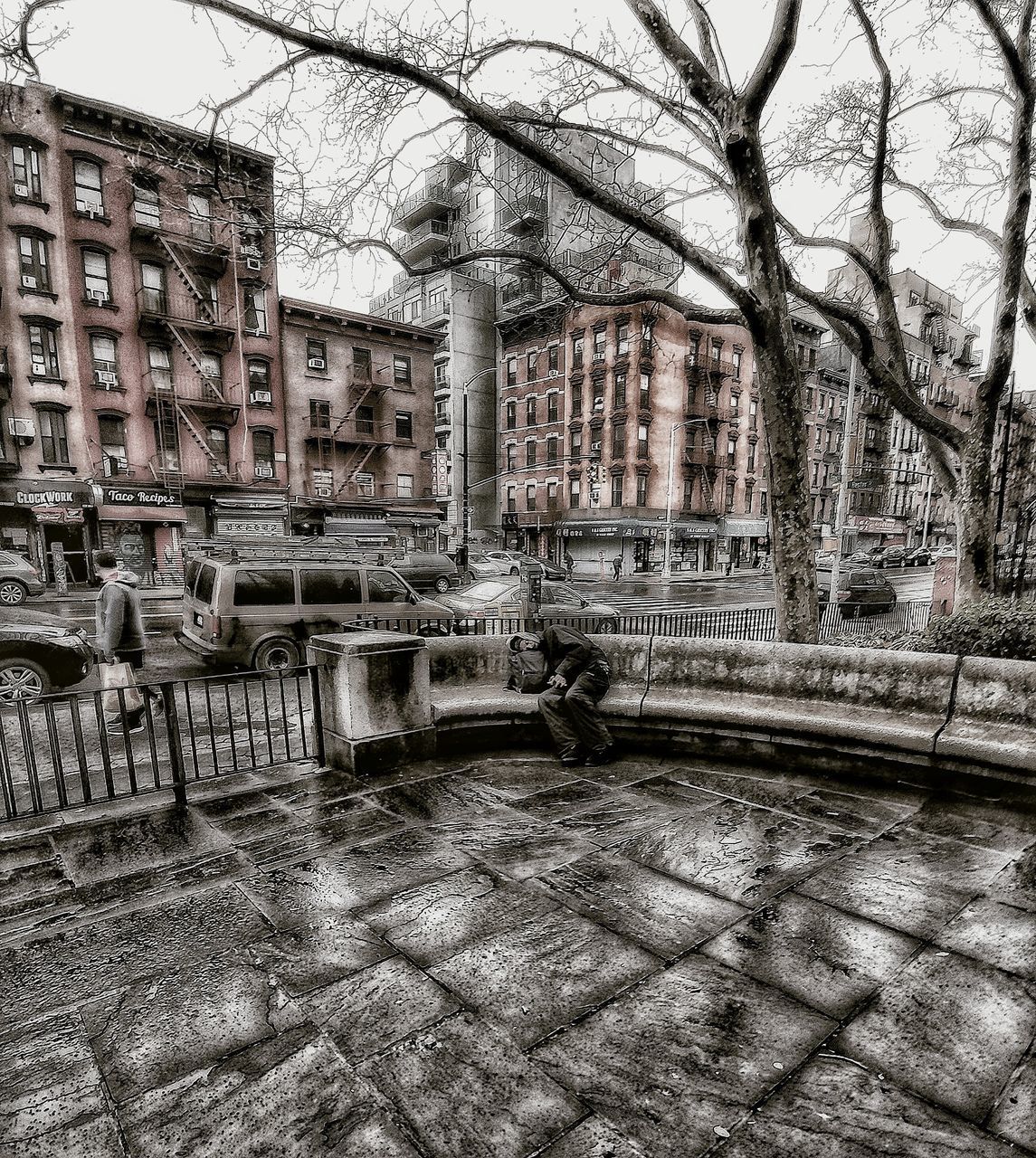 OLD BUILDING BY BARE TREES IN CITY