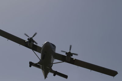 Low angle view of airplane against clear sky