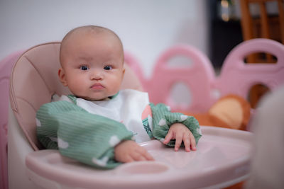 Portrait of cute baby girl in bathtub at home