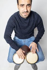 Portrait of man wearing mask against white background