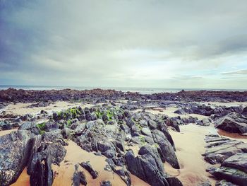 Panoramic view of rocky shore against sky