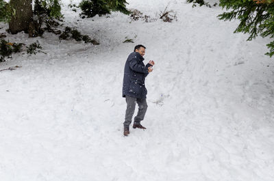 Full length of man standing in snow