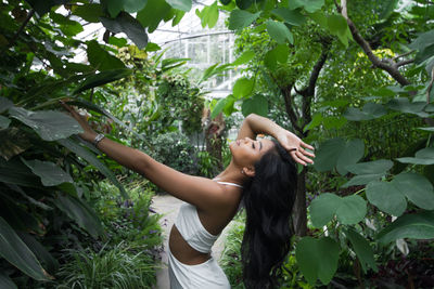 Low angle view of woman standing on tree