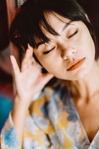 Close-up of young woman with eyes closed