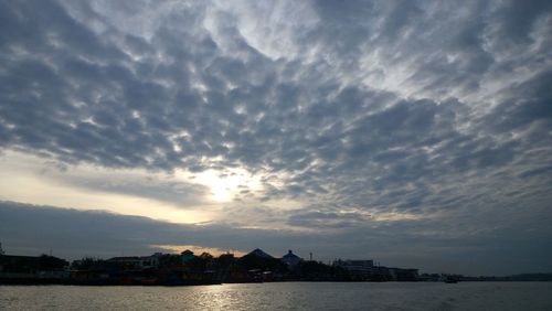 Scenic view of river against cloudy sky