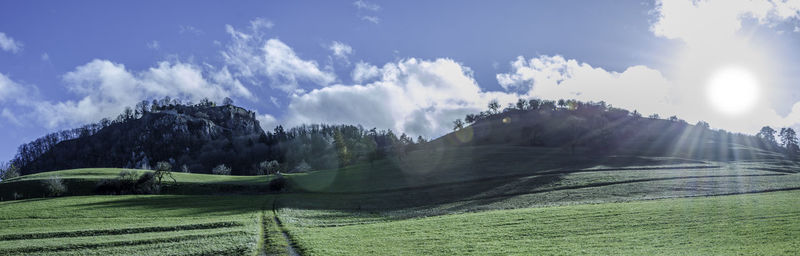 Panoramic view of agricultural field against sky