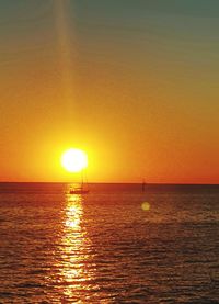 Scenic view of sea against orange sky