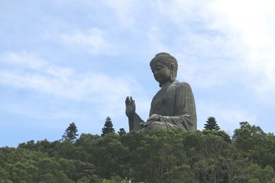 Low angle view of statue against sky