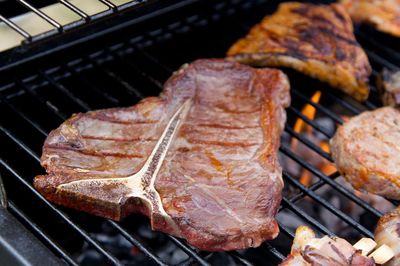 High angle view of meat on barbecue grill