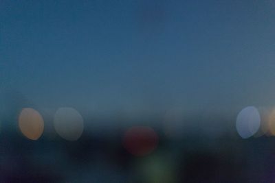 Defocused image of moon against sky at night