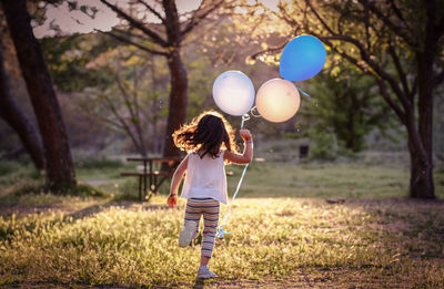 Full length of a girl holding balloons