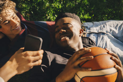 Midsection of man using mobile phone in camera