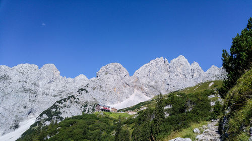 Scenic view of snowcapped mountains against clear blue sky