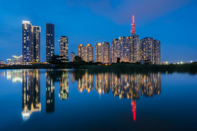 Reflection of illuminated buildings in city