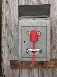 Close-up of red mailbox on door