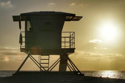 Silhouette of lighthouse at sunset