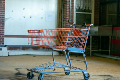 Side view of an abandoned shopping cart at store