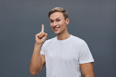 Portrait of young man against black background