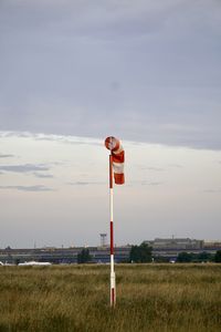 Lifeguard hut on field against sky