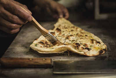 Cropped hand of person preparing food