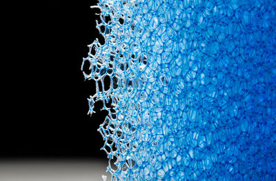 Close-up of blue water against black background