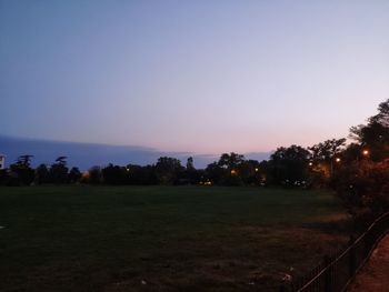 Scenic view of field against clear sky during sunset