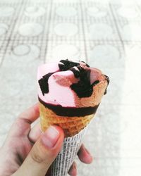 Close-up of woman holding ice cream cone