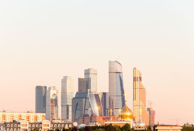 Modern buildings in city against clear sky