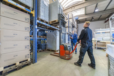 Worker in storage using forklift