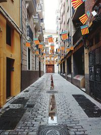 Alley amidst street in city