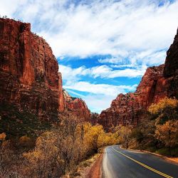 Road amidst rock formation against sky