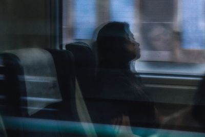 Blurred motion of woman looking through window