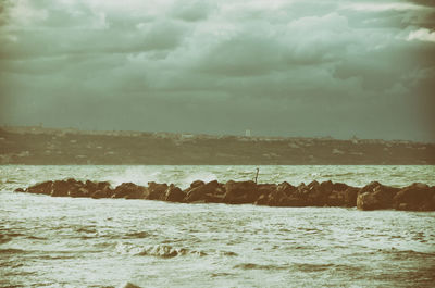 Scenic view of sea against cloudy sky