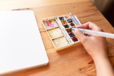 High angle view of person hand on table