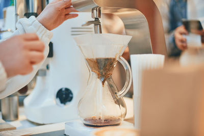 Midsection of woman holding coffee cup