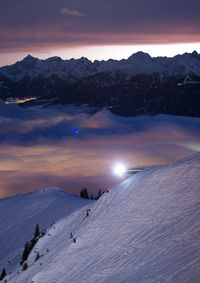 Scenic view of snow covered mountains against sky during sunset