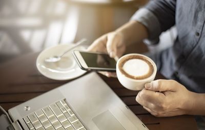 Midsection of coffee cup on table