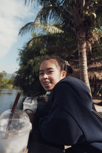 Portrait of smiling boy drinking glass