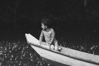 Full length of boy on boat in water