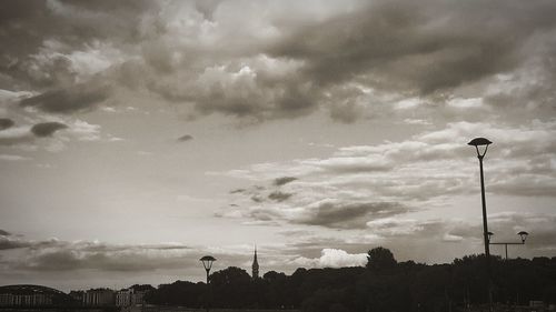 Low angle view of silhouette street light against sky