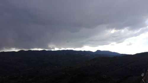 Scenic view of mountains against cloudy sky