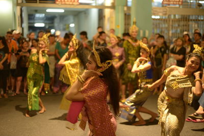 Group of people dancing at music concert