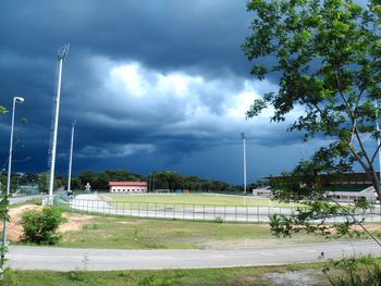 View of country road against cloudy sky