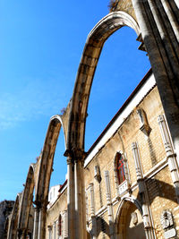 Low angle view of historical building against blue sky. carmo convent. lisbon portugal